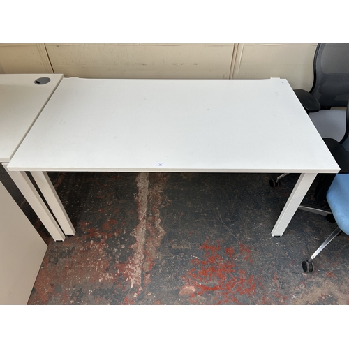 324 - A modern white laminate office desk - approx. 72cm high x 140cm wide x 92cm deep