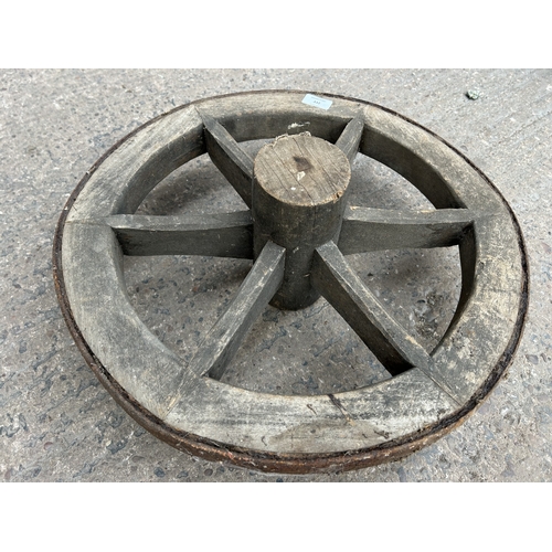 332 - An antique wood and metal cart wheel - approx. 50cm diameter