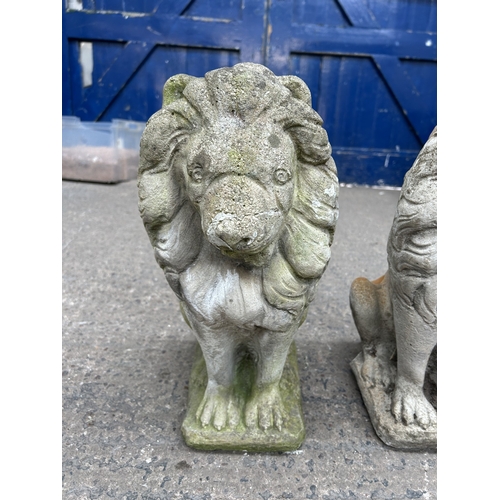 341 - A pair of cast stone lion garden ornaments - approx. 45cm high