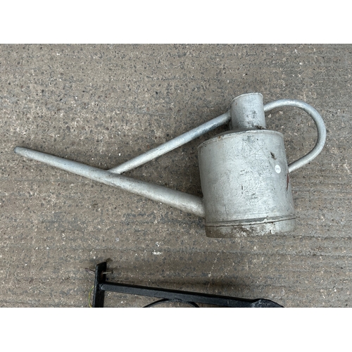 342 - Two items, one galvanised watering can and one black painted wrought metal hanging lantern