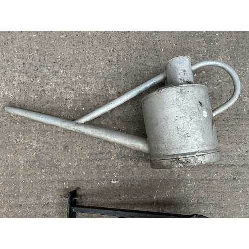 342 - Two items, one galvanised watering can and one black painted wrought metal hanging lantern