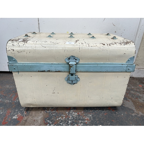 353 - An early 20th century painted metal travel trunk - approx. 42cm high x 59cm wide x 42cm deep