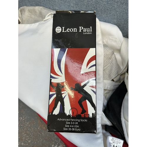 1217 - A collection of Leon Paul fencing equipment to include sabre, mask, gloves etc.