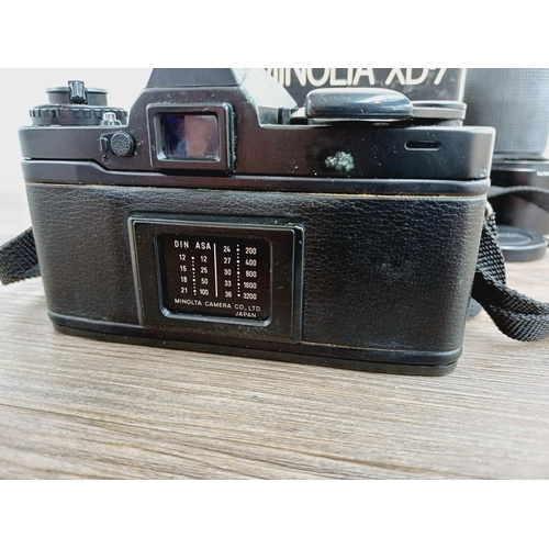 1072 - A boxed black Minolta XG7 35mm SLR camera body with MD 1:4 70-210mm zoom lens with caps, filter and ... 