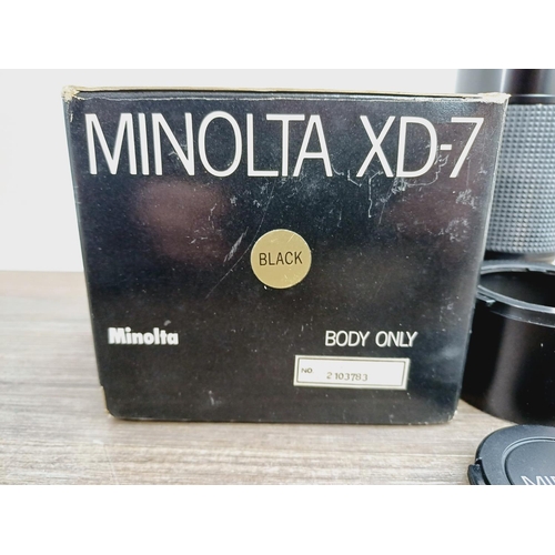 1072 - A boxed black Minolta XG7 35mm SLR camera body with MD 1:4 70-210mm zoom lens with caps, filter and ... 