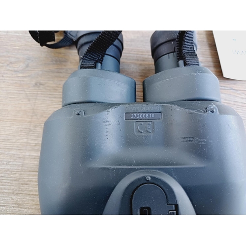 1077 - A cased pair of Canon 10x30 IS Image Stabilizer binoculars with instruction manual