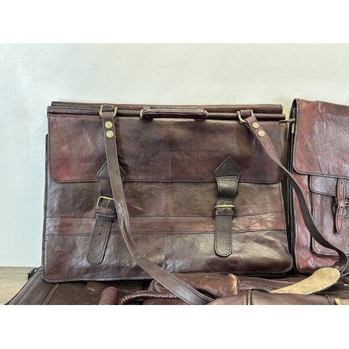 733 - Five red dyed leather accessories, three holdalls and two satchels