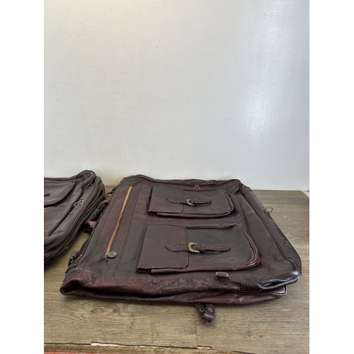 733 - Five red dyed leather accessories, three holdalls and two satchels