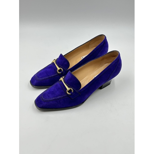 737 - Two pairs of Celine of Paris heeled shoes, one purple suede and one black crocodile skin effect leat... 