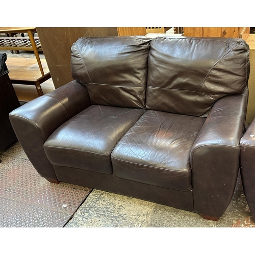 102 - A brown leather three piece lounge suite comprising armchair and pair of two seater sofas