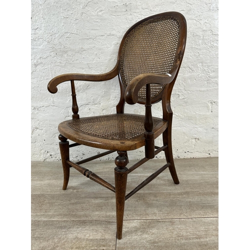 11 - A late 19th/early 20th century mahogany and cane armchair - approx. 93cm high x 57cm wide x 48cm dee... 