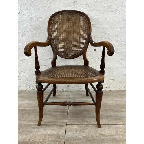 11 - A late 19th/early 20th century mahogany and cane armchair - approx. 93cm high x 57cm wide x 48cm dee... 