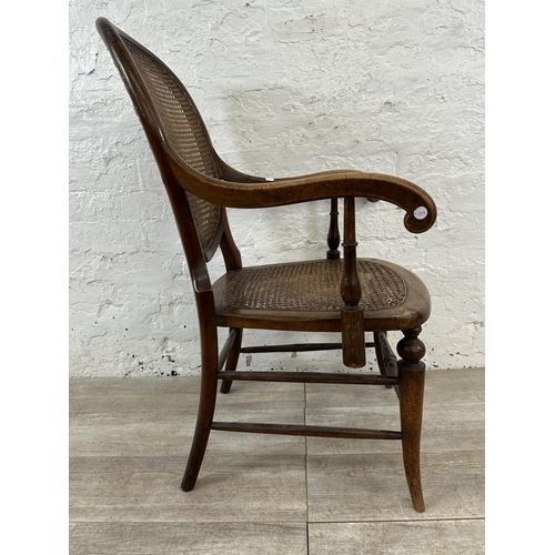 11 - A late 19th/early 20th century mahogany and cane armchair - approx. 93cm high x 57cm wide x 48cm dee... 