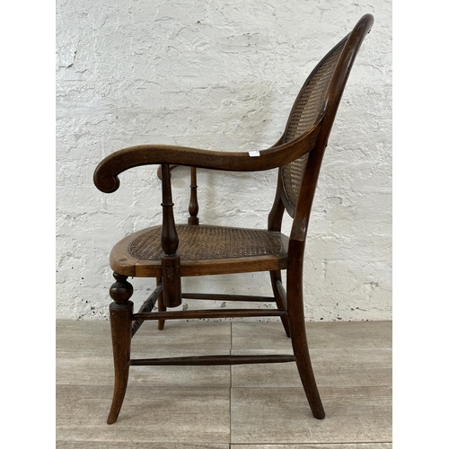 11 - A late 19th/early 20th century mahogany and cane armchair - approx. 93cm high x 57cm wide x 48cm dee... 