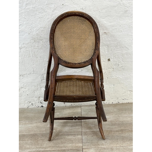 11 - A late 19th/early 20th century mahogany and cane armchair - approx. 93cm high x 57cm wide x 48cm dee... 