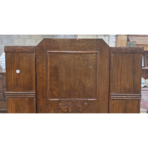 110 - An Art Deco carved oak single door wardrobe - approx. 170cm high x 74cm wide x 41cm deep