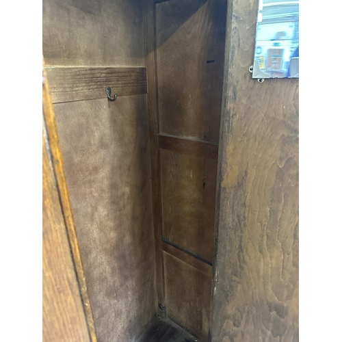 110 - An Art Deco carved oak single door wardrobe - approx. 170cm high x 74cm wide x 41cm deep