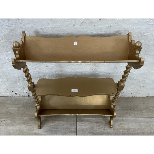 113 - An early 20th century gold painted barley twist three tier book stand - approx. 70cm high x 27cm wid... 