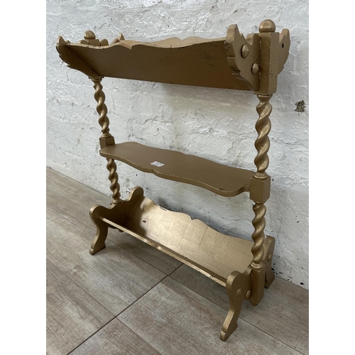 113 - An early 20th century gold painted barley twist three tier book stand - approx. 70cm high x 27cm wid... 