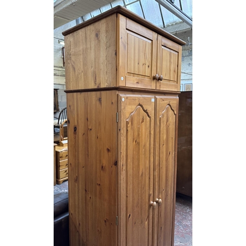 116 - A pine double wardrobe with later added top - approx. 220cm high x 85cm wide x 55cm deep