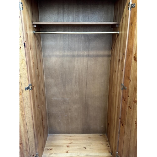 116 - A pine double wardrobe with later added top - approx. 220cm high x 85cm wide x 55cm deep