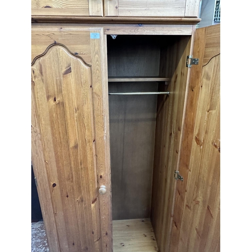 116 - A pine double wardrobe with later added top - approx. 220cm high x 85cm wide x 55cm deep
