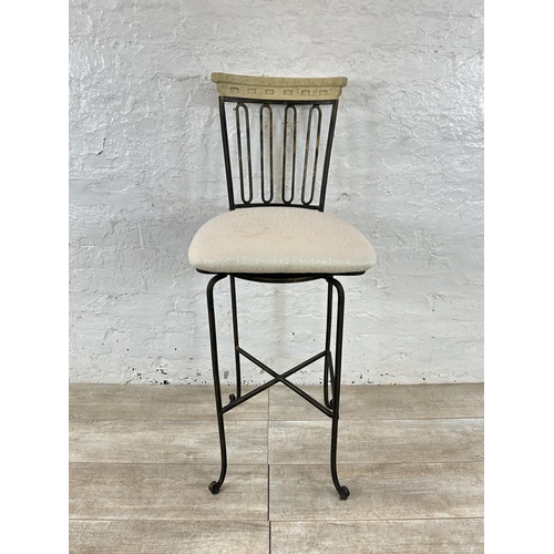 128 - A wrought metal and marble effect swivel bar stool - approx. 112cm high