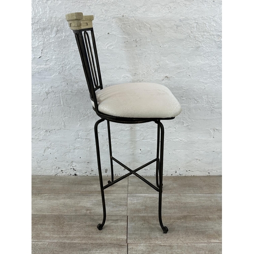 128 - A wrought metal and marble effect swivel bar stool - approx. 112cm high