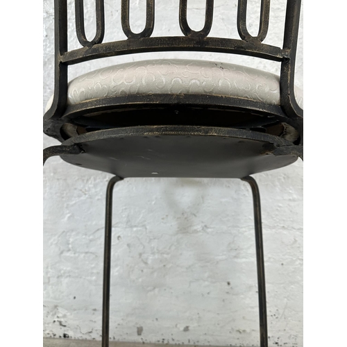 128 - A wrought metal and marble effect swivel bar stool - approx. 112cm high