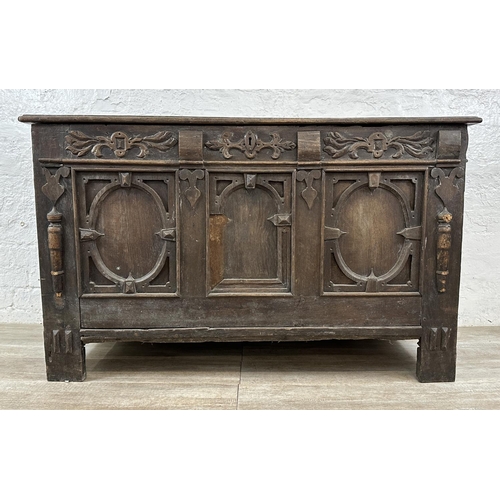 13 - An 18th century carved oak panelled coffer - approx. 78cm high x 127cm wide x 59cm deep