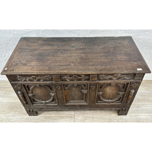 13 - An 18th century carved oak panelled coffer - approx. 78cm high x 127cm wide x 59cm deep