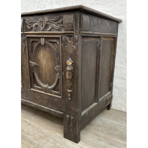 13 - An 18th century carved oak panelled coffer - approx. 78cm high x 127cm wide x 59cm deep