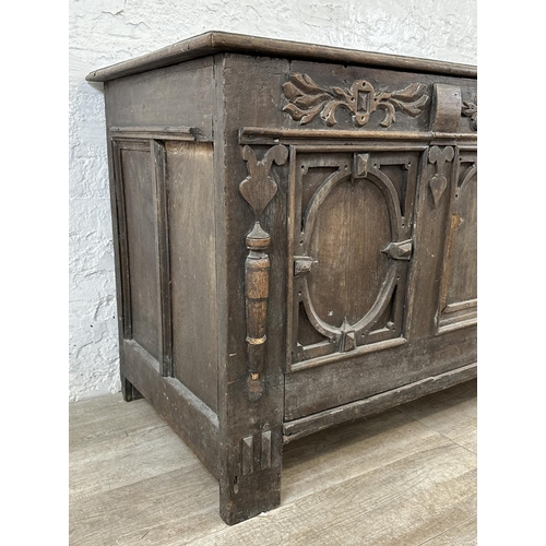 13 - An 18th century carved oak panelled coffer - approx. 78cm high x 127cm wide x 59cm deep