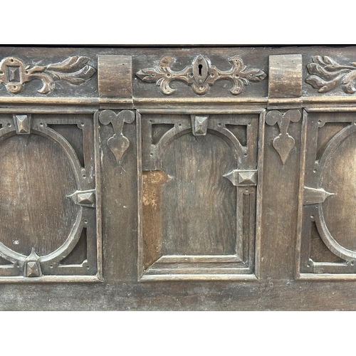 13 - An 18th century carved oak panelled coffer - approx. 78cm high x 127cm wide x 59cm deep