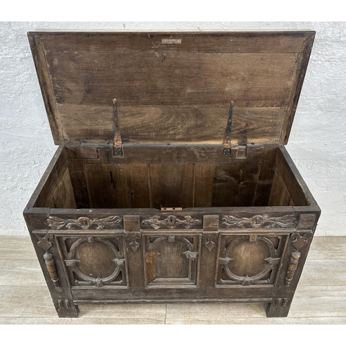 13 - An 18th century carved oak panelled coffer - approx. 78cm high x 127cm wide x 59cm deep