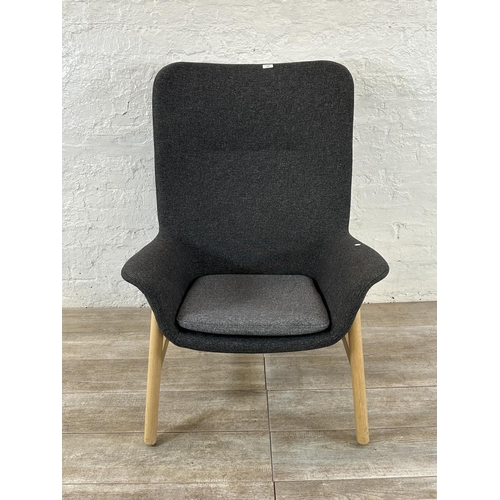 130 - A pair of IKEA grey fabric upholstered and beech armchairs with footstools