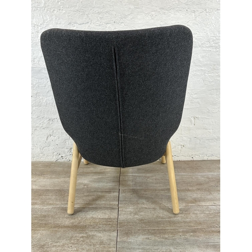 130 - A pair of IKEA grey fabric upholstered and beech armchairs with footstools