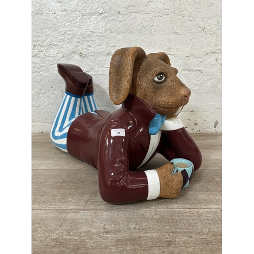 131 - A Natureworks Alice In Wonderland March Hare - Lying fibreglass sculpture - approx. 39cm high x 35cm... 