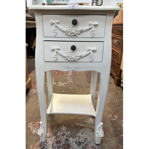 135 - A French style white painted serpentine two drawer bedside table - approx. 76cm high x 39cm wide x 3... 