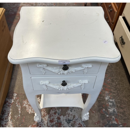 135 - A French style white painted serpentine two drawer bedside table - approx. 76cm high x 39cm wide x 3... 