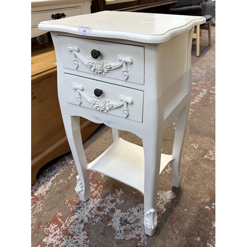 135 - A French style white painted serpentine two drawer bedside table - approx. 76cm high x 39cm wide x 3... 