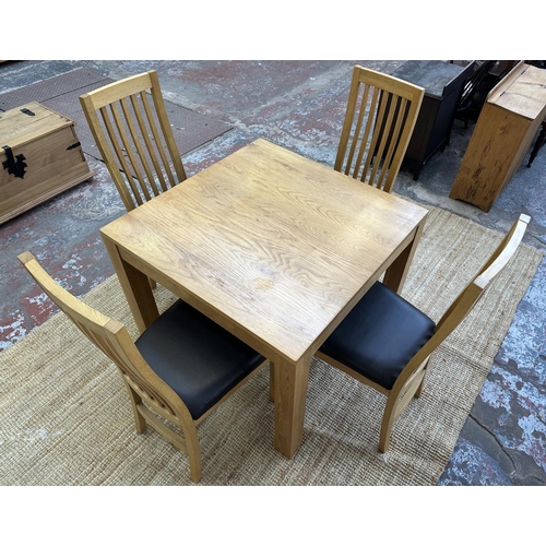 152 - A modern oak square dining table and four chairs - approx. 76cm high x 90cm square