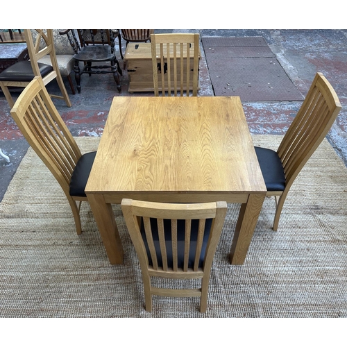 152 - A modern oak square dining table and four chairs - approx. 76cm high x 90cm square