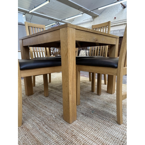 152 - A modern oak square dining table and four chairs - approx. 76cm high x 90cm square