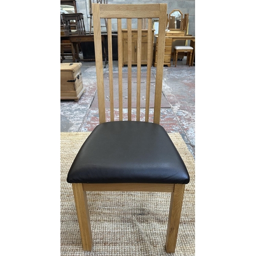 152 - A modern oak square dining table and four chairs - approx. 76cm high x 90cm square