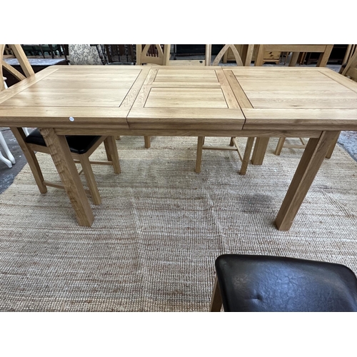 154 - A modern oak extending dining table and six chairs - approx. 77cm high x 90cm wide x 150cm long