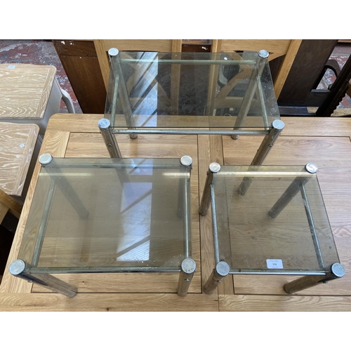 156 - An Italian smoked glass and chrome plated nest of three tables - approx. 47cm high x 52cm wide x 32c... 