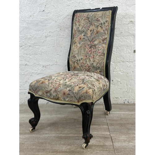 165 - A Victorian ebonised and tapestry upholstered nursing chair on castors - approx. 93cm high x 51cm wi... 