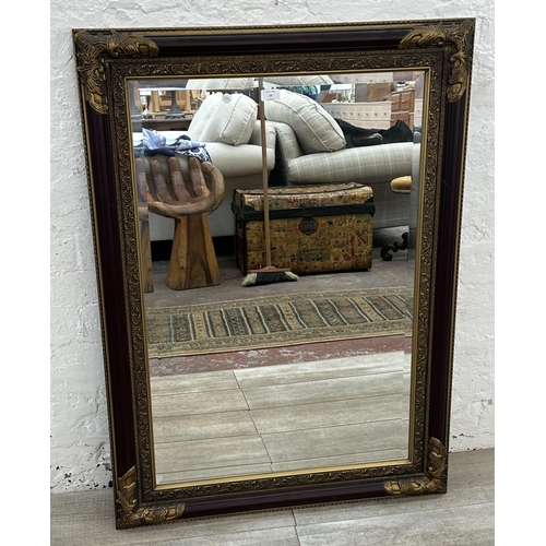 19 - A 19th century style red lacquered and gilt framed bevelled edge wall mirror - approx. 110cm x 79cm