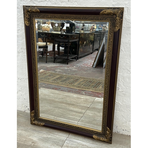 19 - A 19th century style red lacquered and gilt framed bevelled edge wall mirror - approx. 110cm x 79cm